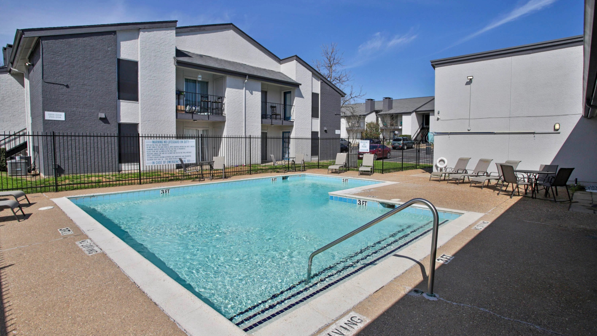 a large swimming pool in front of a building